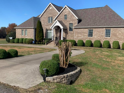 large home with freshly mowed lawn and neatly trimmed hedges 
